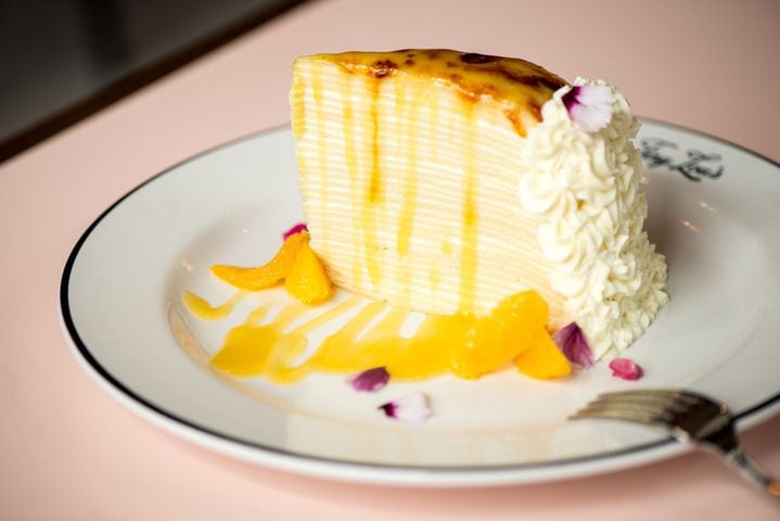 Crepe Suzette Cake dessert with thin French crepes, orange cream, warm beurre suzette, and citrus. Photo credit- Mia Yakel.