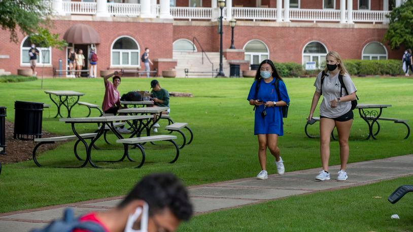 Georgia College and State University freshmen Ashlynn Anglin (right) and Meghan Murphy (second from right) wear face masks as they talk amongst themselves while traveling through the campus in Milledgeville, Friday, Aug. 21, 2020.  (ALYSSA POINTER / ALYSSA.POINTER@AJC.COM)