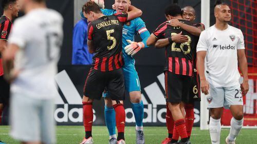 July 21, 2019 Atlanta: Atlanta United goalkeeper Brad Guzan and defender Leandro Gonzalez Pirez (from left) and Dion Pereira and Darlington Nagbe celebrate a 2-0 victory over D.C. United while Quincey Amarikwa walks away dejected as time expires in a soccer match on Sunday, July 21, 2019, in Atlanta.   Curtis Compton/ccompton@ajc.com