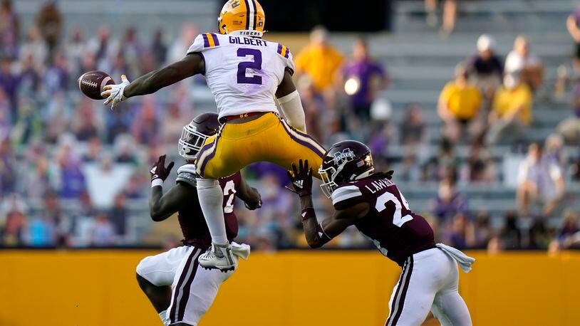 LSU tight end Arik Gilbert (2) tries to pull in a pass against Mississippi State safety Dylan Lawrence (24) and safety Tyrus Wheat. (AP Photo/Gerald Herbert)