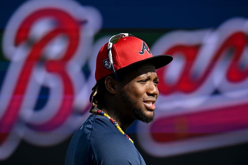 Atlanta Braves right fielder Ronald Acuna Jr. talks with teammates and coaching staff before taking batting practice during spring training workouts at CoolToday Park, Friday, February, 16, 2024, in North Port, Florida. (Hyosub Shin / Hyosub.Shin@ajc.com)