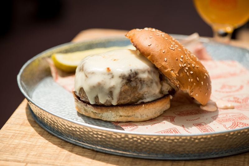  Barleygarden the Big Braut Burger with grilled pork bratwurst, Swiss cheese, Russian dressing, carmelized onions, on a buttered sesame bun. Photo credit- Mia Yakel.