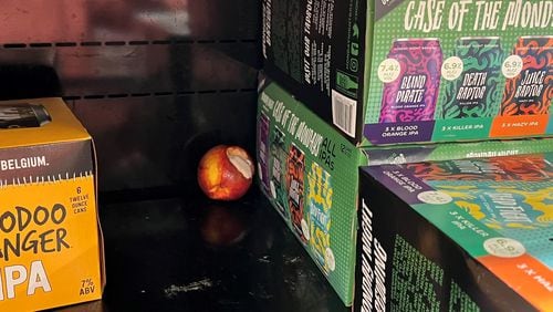 Residents have complained about the cleanliness at the Kroger Metropolitan Citi-Center. They have shown the alcohol License Review Board photos of litter on the shelves, including a half-eaten apple. Image credit: Neighborhood Planning Unit-X