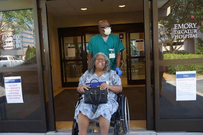 Coronavirus survivor Janice Cockfield beams on July 17, 2020, as she is discharged from Emory Decatur Hospital's inpatient rehab facility in metro Atlanta. "She was sooo happy to see four of her sisters waiting to pick her up," said her twin, Janese Cockfield. Janice's recovery from COVID-19 after 110 days of hospitalization stunned Emory medical professionals. She spent more than two months in the ICU at Emory University Hospital Midtown, most of that time on a ventilator. (Credit: Janese Cockfield / Contributed)