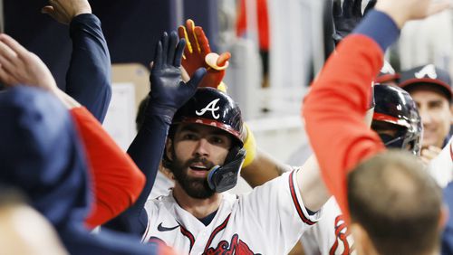 Braves shortstop Dansby Swanson (7) gets high fives at the dugout after hitting a two-run home run during the fifth inning of a baseball game against the New York Mets at Truist Park on Saturday, Oct. 1, 2022. Miguel Martinez / miguel.martinezjimenez@ajc.com