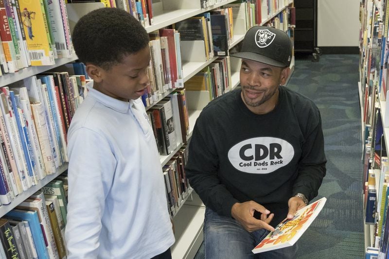 The birth of his son Anderson, now 8, and spending time with him led La Verio Barnes to create the charity Cool Dads Rock, a community of fathers celebrating the importance and influence of dads in their children’s lives. Here, they’re together at the Kirkwood Branch library. DAVID BARNES / DAVID.BARNES@AJC.COM