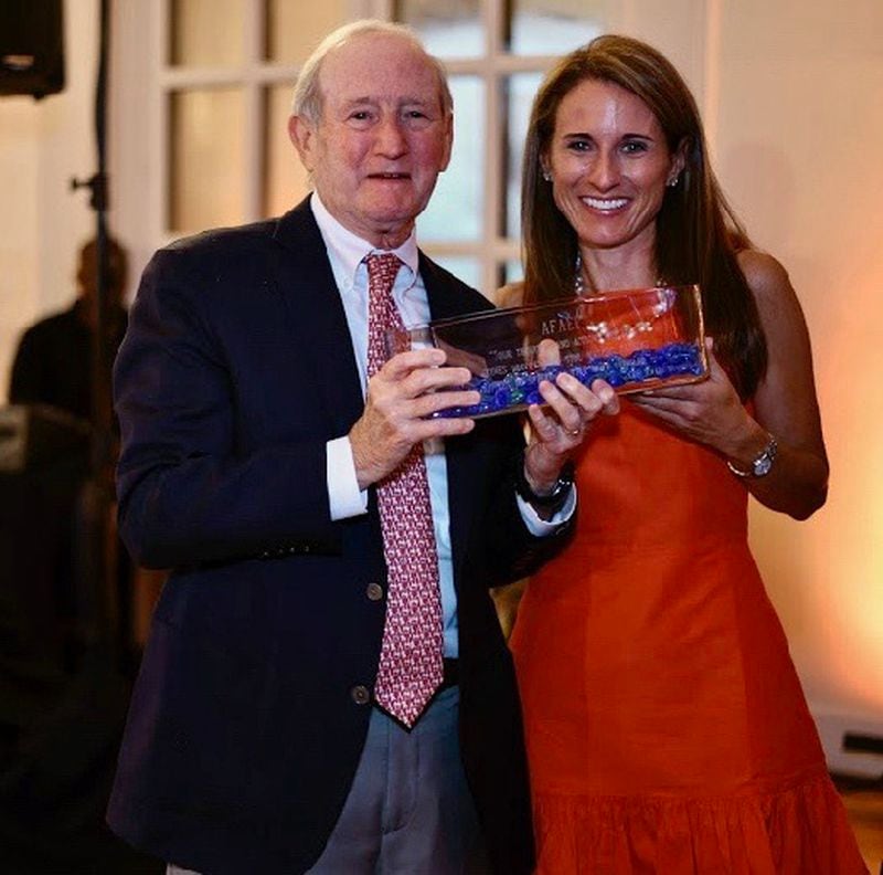 Ed Michaels receiving an award for his efforts to shine a bright light on educators in Metro Atlanta public schools with his daughter, Katie Post.