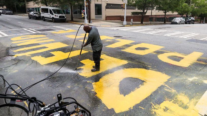 The message was painted in yellow letters outside of Atlanta Police Department headquarters. A city employee pressure-washed the paint off the road Wednesday morning.