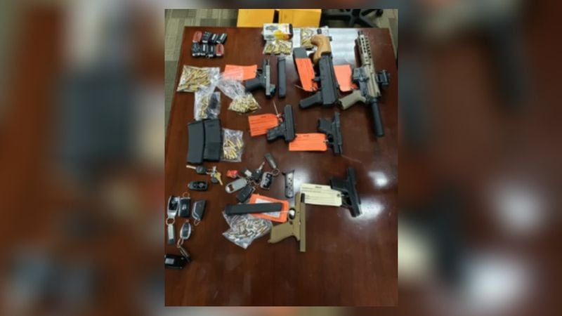 Authorities raided three Fulton County homes Thursday and recovered five handguns, two assault rifles, key fobs to six stolen vehicles, more than 100 rounds of ammo as well as equipment used to steal the automobiles.