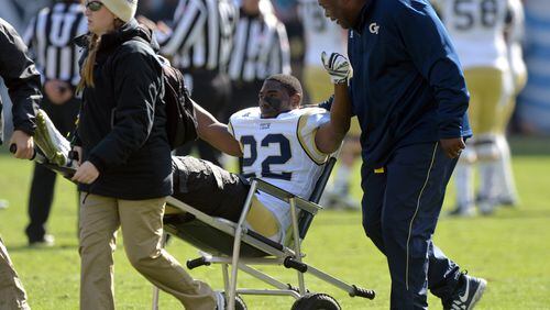 November 15, 2014 Atlanta - Georgia Tech Yellow Jackets running back Broderick Snoddy (22) pumps his fists in the air as he is helped off of the field after being injured in the first half at Bobby Dodd Stadium on Saturday, November 15, 2014. HYOSUB SHIN / HSHIN@AJC.COM