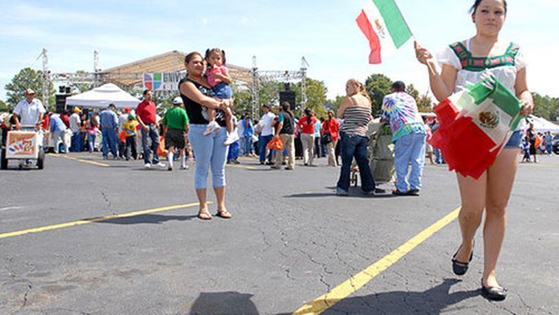 Susana Olague sells Mexican flags during the celebration at Plaza Fiesta.
