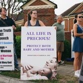 Protesters from Operation Save America canvas outside of an abortion clinic in Forest Park in July. (Olivia Bowdoin for The Atlanta Journal-Constitution)