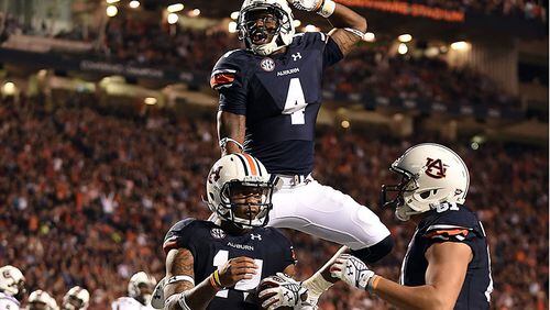 Nick Marshall #14 of the Auburn Tigers celebrates a touchdown with Quan Bray #4 during the fourth quarter of a game against the South Carolina Gamecocks at Jordan Hare Stadium on October 25, 2014 in Auburn, Alabama. (Photo by Stacy Revere/Getty Images)