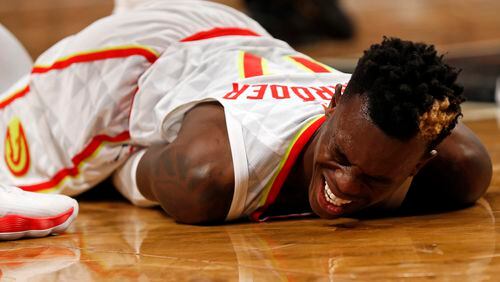 Atlanta Hawks' Dennis Schroder reacts after an injury during the fourth quarter of an NBA basketball game against the Brooklyn Nets, Sunday, Oct. 22, 2017, in New York. (AP Photo/Adam Hunger)