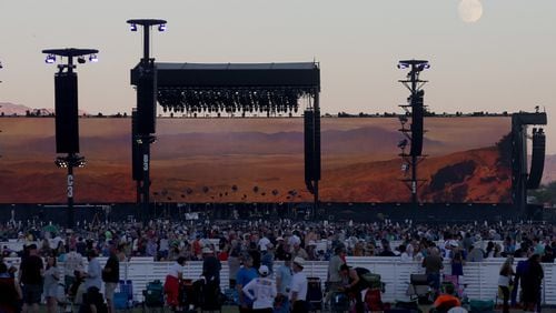 The moon rises over the stage as music fans wait for Bob Dylan to perform at the Empire Polo Grounds on the second weekend of Desert Trip in Indio, Calif., on Friday, Oct. 14, 2016. (Luis Sinco/Los Angeles Times/TNS)