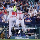 Atlanta Braves designated hitter Marcell Ozuna, right, celebrates his home run with third base coach Matt Tuiasosopo (89) as he round the bases during the second inning of a baseball game against the Houston Astros Wednesday, April 17, 2024, in Houston. (AP Photo/Michael Wyke)