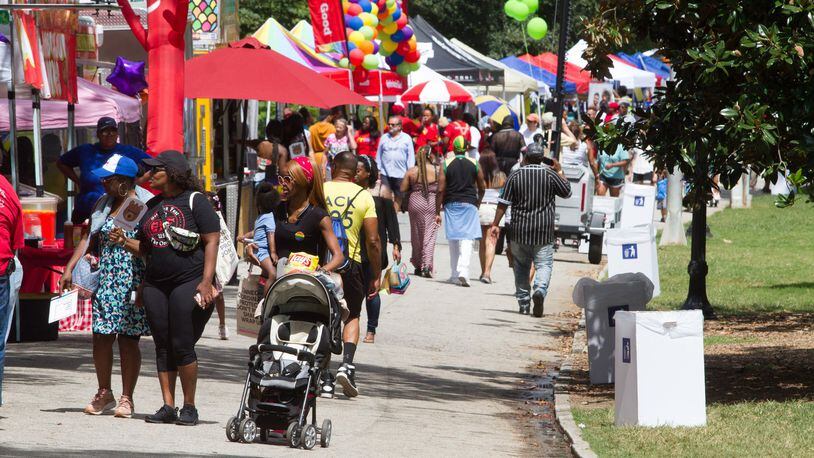People walk past the vendor booths during the Pure Heat Community Festival during Atlanta Black Pride weekend in 2019. STEVE SCHAEFER / SPECIAL TO THE AJC