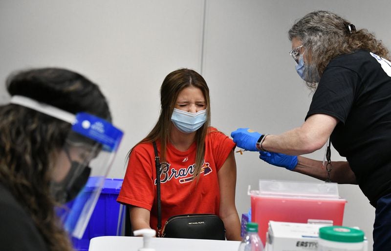 An Atlanta Braves receives a COVID-19 vaccine earlier this year at Truist Park. (Hyosub Shin / Atlanta Journal-Constitution)