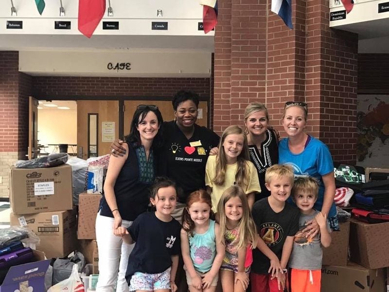 Caitlin Zygmont (left), with Principal Kindra Smith, Devon Tarter and Carson Schefstad and their children at Elkins Pointe Middle School. Zygmont, Tarter and Schefstad spearhead Edenwilde Cares, which donated school supplies, snacks and dress shirts recently to the Title I school. CONTRIBUTED