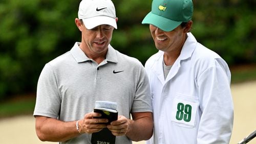 Rory McIlroy talks with his caddie Harry Diamond as he practices on the 13th green during the practice round of the 2024 Masters Tournament at Augusta National Golf Club, Tuesday, April 9, 2024, in Augusta. (Hyosub Shin / Hyosub.Shin@ajc.com)
