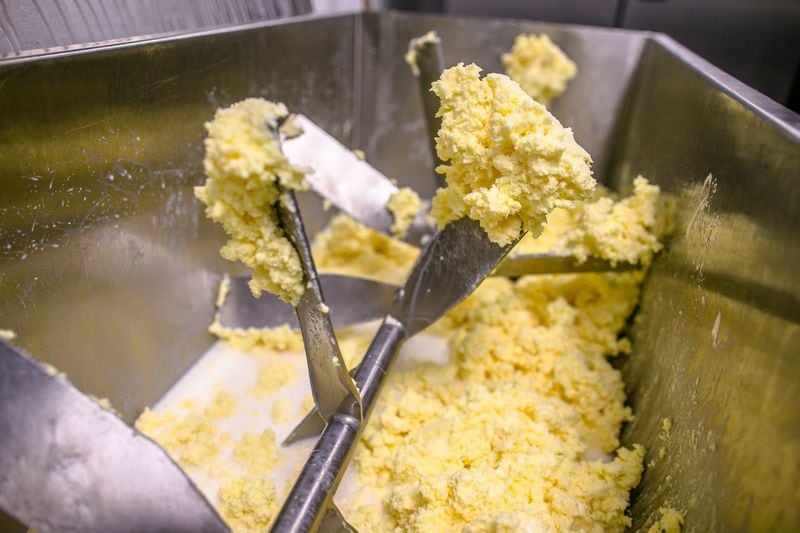 This is butter at the "popcorn" stage where the buttermilk separates from the butter. At this point, the buttermilk is drained and then begins the slow process of working the butter to enhance its taste and texture or creaminess.