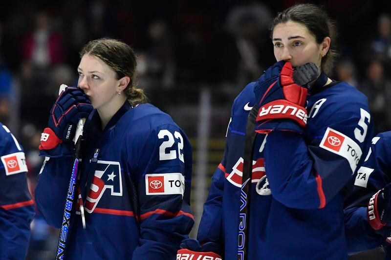 United States forward Tessa Janecke, left, and defensewoman Megan Keller react as they watch Canada celebrate their win in the final at the IIHF Women's World Hockey Championships in Utica, N.Y., Sunday, April 14, 2024. (AP Photo/Adrian Kraus)