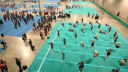 Hundreds of cheerleaders practice in the warm up area. (AJC File photo)