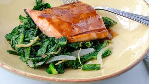 Teriyaki salmon on a bed of sauteed greens with ginger and onion is a dish that comes together quickly.
(Courtesy of Virginia Willis /Food styling Cynthia Graubart)