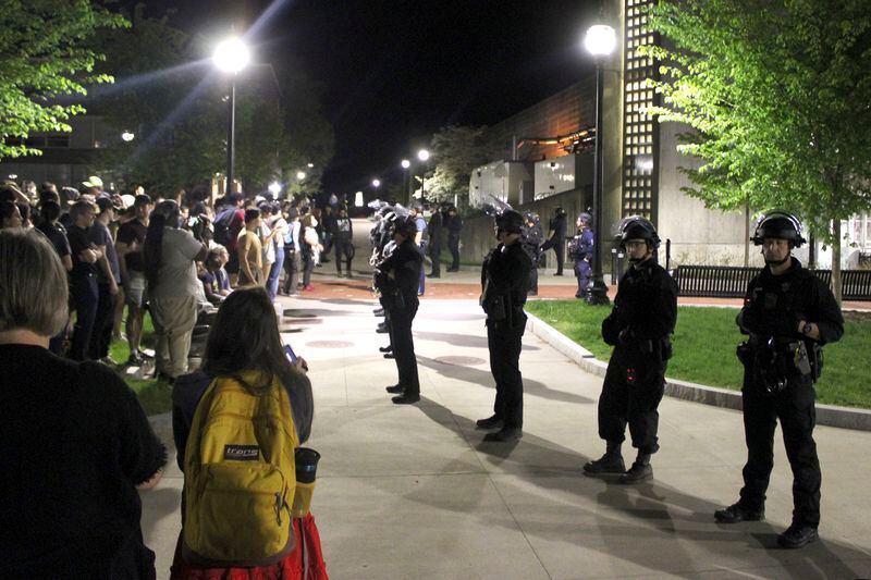 Members of law enforcement form a line, Wednesday, May 8, 2024, on the University of Massachusetts Amherst campus, in Amherst, Mass. Police moved in Tuesday night to break up an encampment at the school, in what appeared in video to be a hours-long operation as dozens of police officers in riot gear systematically tore down tents and took protesters into custody. The protesters established the tent encampment to demonstrate against the war in Gaza. (Kalinka Kornacki via AP)