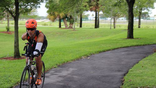 Hector Picard, a double arm amputee who competes in triathlons, has a customized bike where the brakes are moved from the handlebars to the frame, and he uses his right knee to apply the rear and front brakes. He has a specialized sling where his left arm can be attached to the handlebars so he can steer, and he electronically shifts gears using his chin. CONTRIBUTED BY NOVATION SETTLEMENT SOLUTIONS