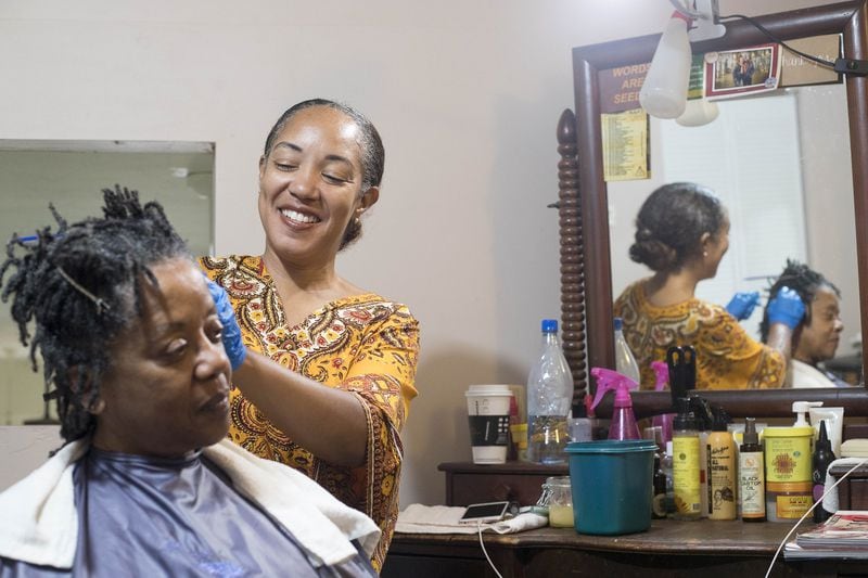 Hairstylist Erica Blevins (right) retwists Gwendolyn Pilot’s locs at the Oh My Nappy Hair salon in downtown Atlanta. Blevins’ mother opened the first location in Oakland, Calif., in 1987 to provide black women with an alternative to the harsh chemicals in hair care products on the market. A recent study found that black women are more likely to be exposed to dangerous chemicals in the hair care products they use. ALYSSA POINTER / ALYSSA.POINTER@AJC.COM