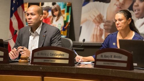 Atlanta school board chairman Jason Esteves (left) and Superintendent Meria Carstarphen listen to public comment during a special meeting to discuss whether to extend Carstarphen’s contract. (Photo by Phil Skinner).