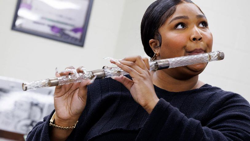 A photo provided by Shawn Miller and the Library of Congress shows Lizzo practicing with James Madison’s flute before bringing it onstage during her concert at Capital One Arena in Washington. A classically trained flutist, the singer, rapper and songwriter spent more than three hours admiring the flute collection at the Library of Congress. (Shawn Miller/Library of Congress via The New York Times) — EDITORIAL USE ONLY—