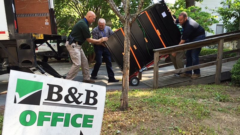 Georgia Department of Revenue agents haul away a file cabinet full of tax returns from B & B Accounting and Tax Services in Hapeville on May 6, 2016. The agency is investigating the business operated by Ruth Barr, a member of the Hapeville City Council.
