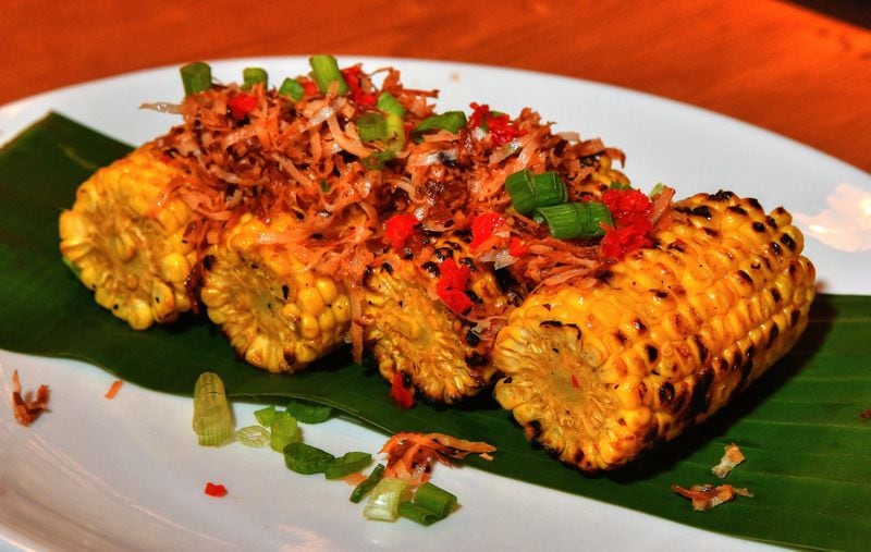 Street corn from Caribbean concept Locale Cafe is showered with shaved coconut. (Chris Hunt for The Atlanta Journal-Constitution)