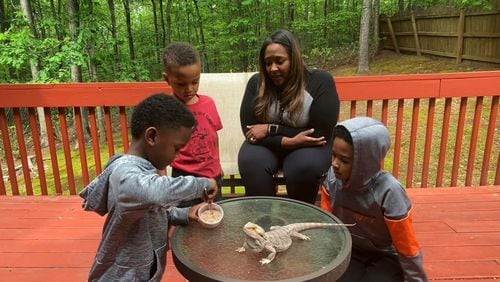Cori Cain, director of strategic partnerships at the Rollins Center for Language and Literacy of the Atlanta Speech School, leads a lesson for the Pop-Up Early Learning program with her three sons and their pet lizard. Submitted photo