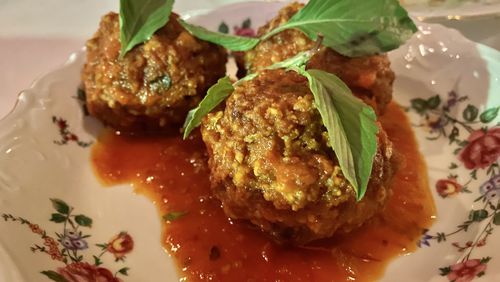 The hint of lemongrass mixed with ground pork sausage takes So So Fed's sai gok meatballs, ladled with mild tomato sauce, into unexpected territory. Ligaya  Figueras/ligaya.figueras@ajc.com