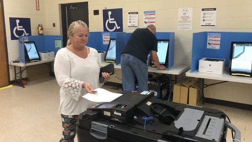 Cathy Watkins of Cartersville inserts her printed-out ballot into a scanner Thursday after voting on Georgia’s new voting machines. Voters in six counties across the state, including Bartow County and its city of Cartersville, are testing the new voting system in this fall’s elections. Voters across Georgia will use the machines in the March 24 presidential primary. MARK NIESSE / MARK.NIESSE@AJC.COM