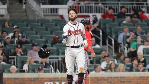 Braves shortstop Dansby Swanson throws his helmet after striking out April 11 at Truist Park. Gauging Swanson’s value never has been easy. His career hasn’t borne out his draft station, but he has been a solid player. (Miguel Martinez/miguel.martinezjimenez@ajc.com)