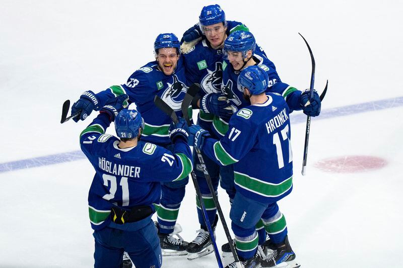 Vancouver Canucks' Nils Hoglander, Teddy Blueger, Nikita Zadorov, Ilya Mikheyev and Filip Hronek celebrate Zadorov's goal against the Edmonton Oilers during the third period of Game 1 of a second-round NHL hockey Stanley Cup playoffs series, Wednesday, May 8, 2024, in Vancouver, British Columbia. (Ethan Cairns/The Canadian Press via AP)