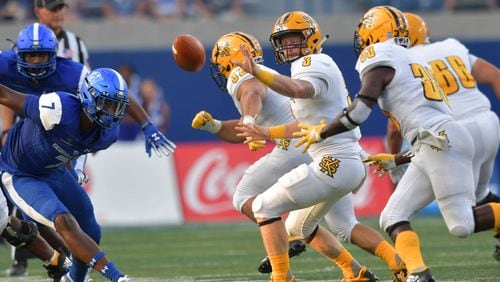 August 30, 2018 Atlanta - Kennesaw State quarterback Chandler Burks (3) tosses the football to Kennesaw State running back Darnell Holland (33) in the first half during the 2018 season opening game against Kennesaw State at Georgia State Stadium on Thursday, August 30, 2018. HYOSUB SHIN / HSHIN@AJC.COM