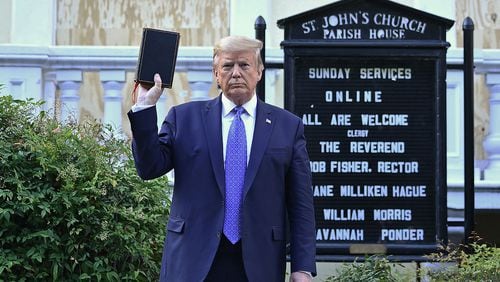 President Donald Trump holds up a Bible outside of St John's Episcopal Church on June 1, 2020, in Washington, D.C. (Brendan Smialowski/AFP/Getty Images/TNS)