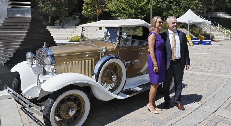 Georgia Tech’s new president, Ángel Cabrera, walked around campus, including this stop at the Ramblin’ Wreck with his wife, Dr. Beth Fraser Cabrera, after he gave his first address since arriving on campus Sept. 1. BOB ANDRES / ROBERT.ANDRES@AJC.COM