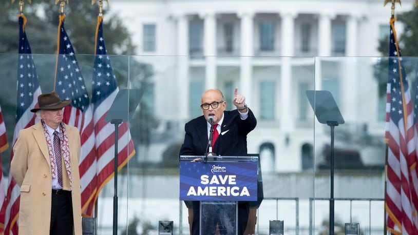 Rudy Giuliani speaks to supporters from The Ellipse near the White House on Jan. 6, 2021, in Washington, D.C. Standing by and watching is lawyer John Eastman. (Brendan Smialowski/AFP/Getty Images/TNS)