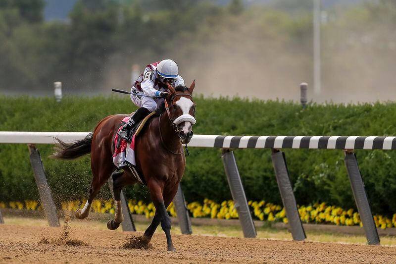 Tiz the Law (8), with jockey Manny Franco up, approaches the finish line on his way to win the152nd running of the Belmont Stakes horse race, Saturday, June 20, 2020, in Elmont, N.Y. (AP Photo/Seth Wenig)