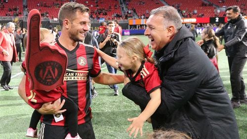 Atlanta United manager Gerardo Martino and Kevin Kratz celebrate a 2-1 victory over the Chicago Fire during a MLS soccer match on Sunday, Oct 21, 2018, in Atlanta.   Curtis Compton/ccompton@ajc.com