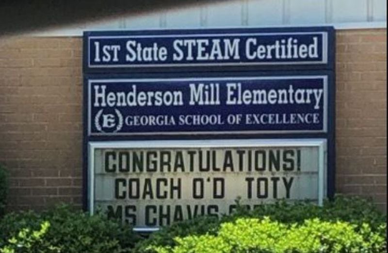 A sign at Henderson Mill Elementary School announces, "Congratulations Coach OD, TOY."  On Friday, the principal told him he could not receive the honor.