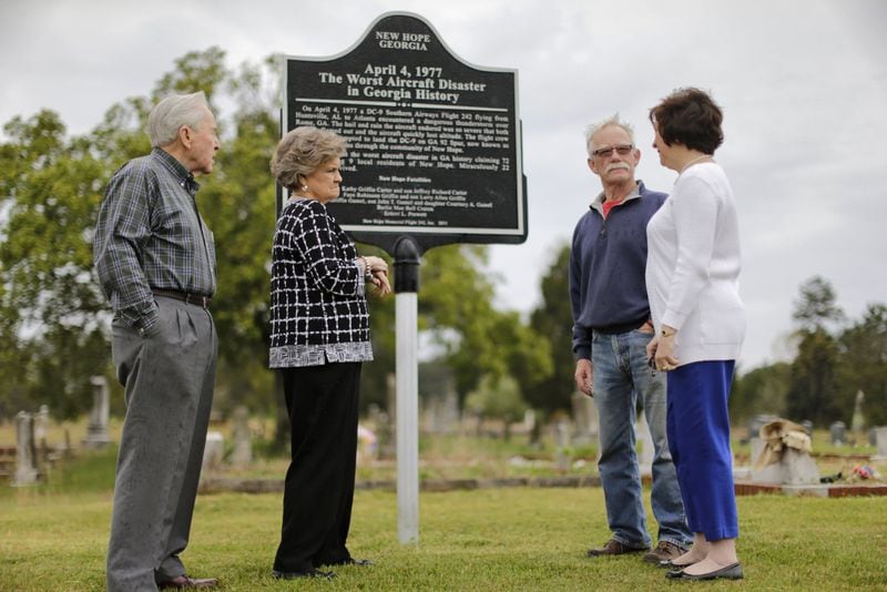 New Hope Memorial Flight 242 board members Loran Wills (from left), Peggy Wills, Hugh Walters and Cherry Waddell at the site of the current marker memorializing the crash. BOB ANDRES / BANDRES@AJC.COM