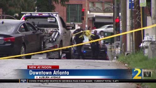 A man was found shot to death Saturday morning in a car that crashed into a building near downtown Atlanta. The incident was one of three shootings reported overnight.