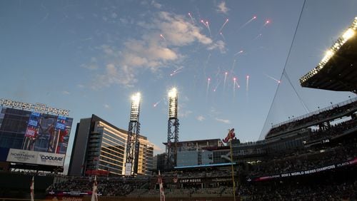 Fireworks explode after the 2021 pennant is revealed before the start of the game with the Cincinnati Reds at Truist Park Thursday, April 7, 2022 (Steve Schaefer / steve.schaefer@ajc.com)